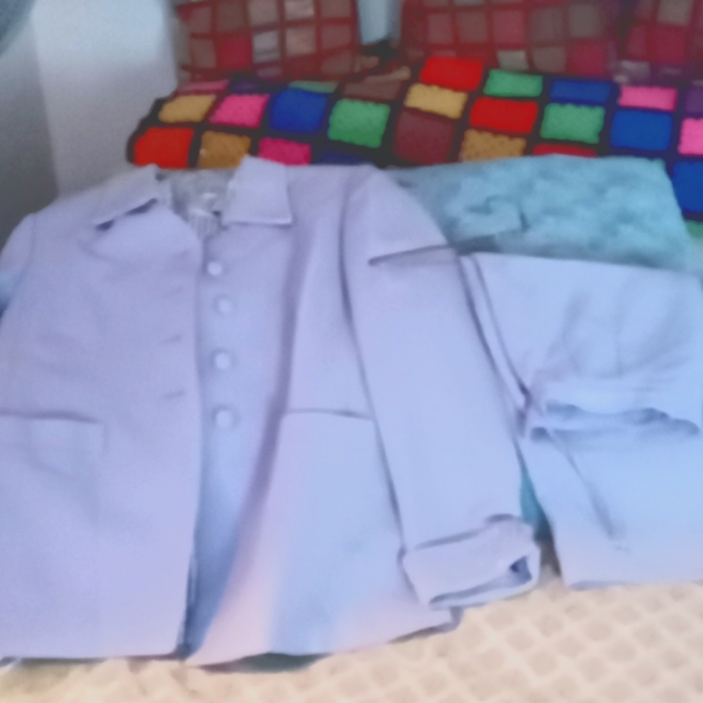 Ladies lilac suit with clear sequence on collar and on front of skirt .